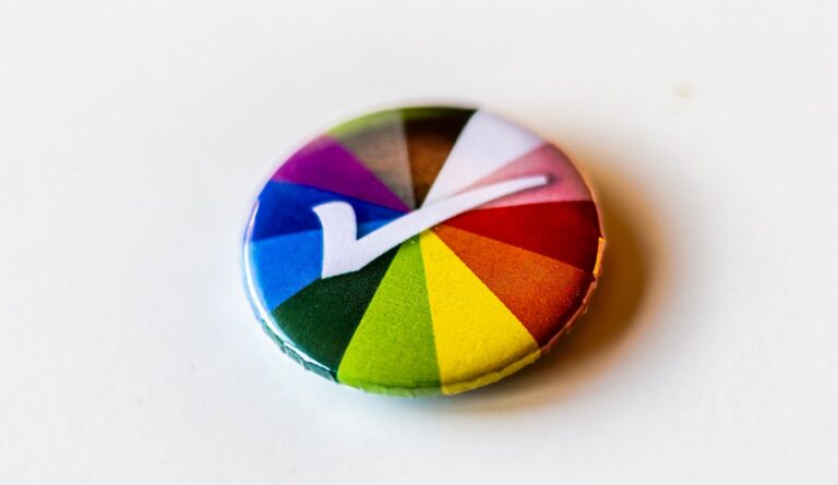 A colorful button with a letter v on it