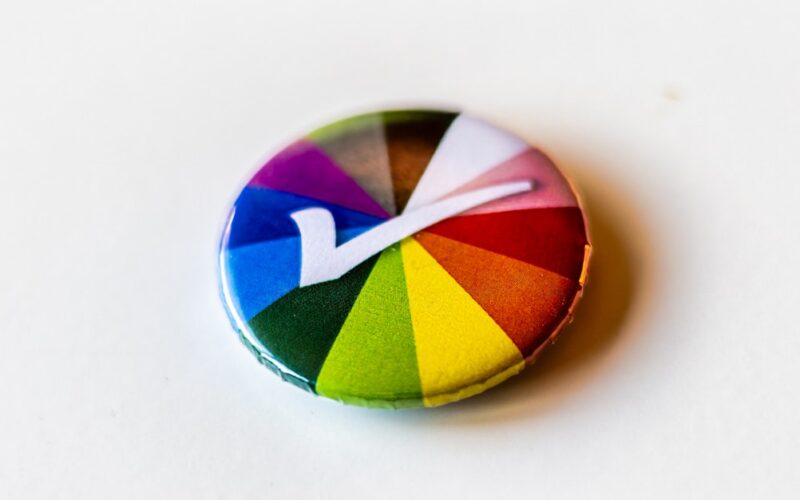 A colorful button with a letter v on it