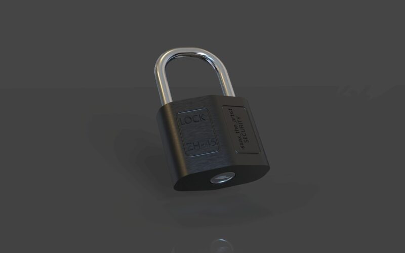 a closed padlock on a black surface